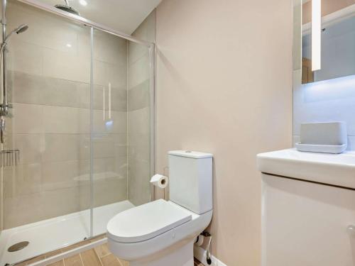 a white bathroom with a toilet and a shower at 1 Bed in Crackington Haven 93958 in Jacobstow