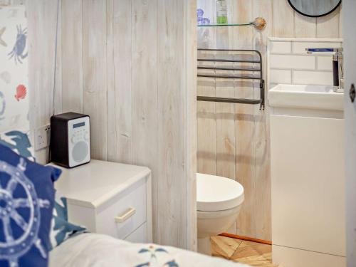 a small bathroom with a toilet and a sink at 1 Bed in Bridport 94154 in Chideock