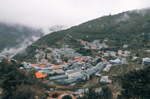 a town on a hill with a mountain at Mountain Lodges of Nepal - Namche in Namche
