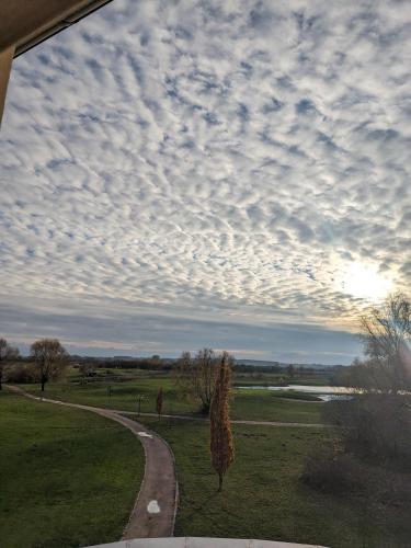 a path in a field with a cloudy sky at Schloss Krugsdorf Golf & Hotel in Krugsdorf