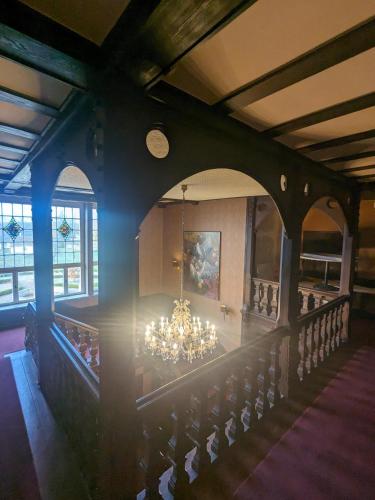a dining room with a chandelier in a building at Schloss Krugsdorf Golf & Hotel in Krugsdorf