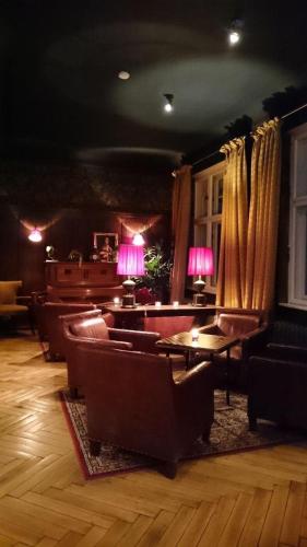 a living room with couches and chairs and lamps at Schloss Krugsdorf Golf & Hotel in Krugsdorf