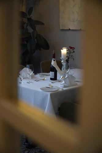a table with a bottle of wine and a candle at Schloss Krugsdorf Golf & Hotel in Krugsdorf