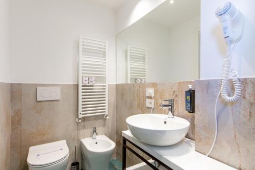 a bathroom with a sink and a toilet and a shower at Hotel Grazia Riccione in Riccione