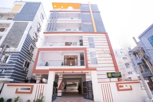 a building in the middle of a city at Yellow Bells Serviced Apartments Hitech City in Kondapur