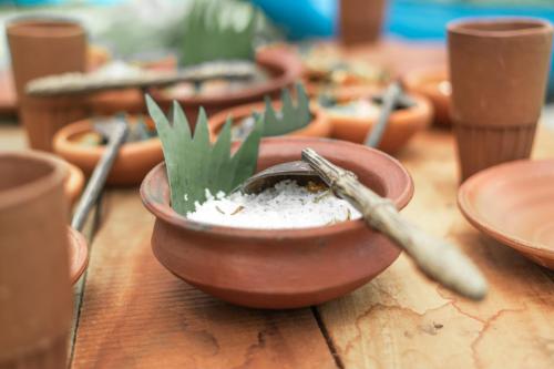 a wooden table with a bowl with a plant in it at Sun Siyam Pasikudah in Pasikuda