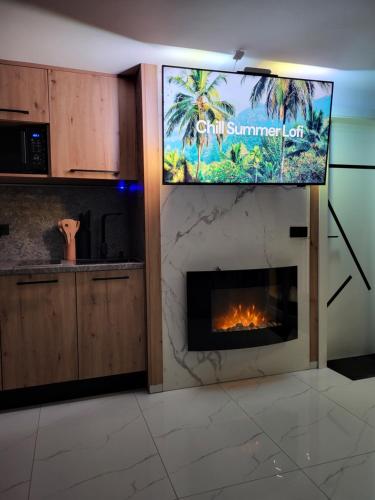 a kitchen with a fireplace with a tv above it at Adriatic SPA Apartment in Selce