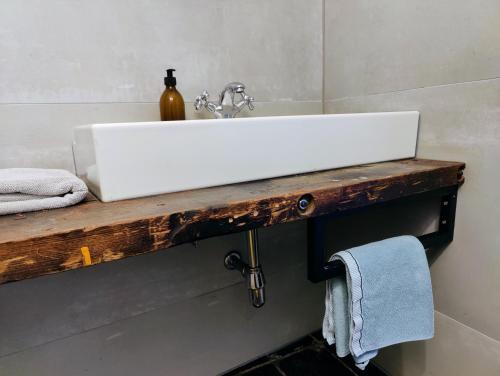 a white sink on a wooden counter in a bathroom at Wetterdelle in Heers