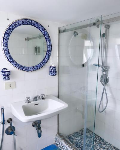 a bathroom with a sink and a glass shower at Suite Villa Carolina in Capri