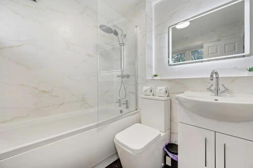uma casa de banho com um WC, um lavatório e um chuveiro em Pass the Keys Superb 3 bed Close to Airport em Wythenshawe