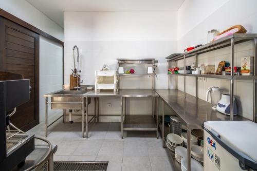 a large kitchen with stainless steel appliances in it at BougainVilla - Oceanfront villa with Cook, ideal for Weddings and Events in Keramas