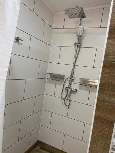 a bathroom with a shower with white tiled walls at Ferienwohnung Kornkäfer 2 in Mochau