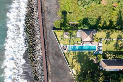 an aerial view of a house next to the ocean at BougainVilla - Oceanfront villa with Cook, ideal for Weddings and Events in Keramas