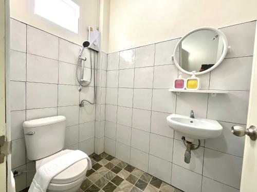 a bathroom with a toilet and a sink and a mirror at Yourbed & House in Bang Rak Beach