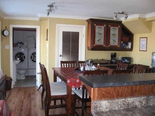 a kitchen and dining room with a table and chairs at Whitsha Inn B&B in Twillingate