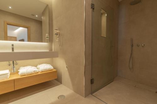 a bathroom with a shower and a sink at Ana's Apartments in Sines