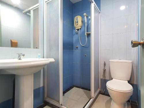 a bathroom with a shower and a toilet and a sink at Capital O 90939 Sandakan Central Hotel in Sandakan