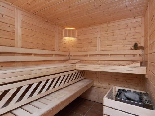 a sauna with wooden benches and a heater at Apartment with sauna in Eschfeld in Eschfeld