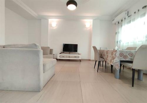 a living room with a couch and a table at ORION RESIDENCY BONABERIE in Douala