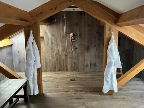 a bathroom with a shower in a wooden wall at Manor House Lindley in Huddersfield