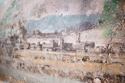 a painting of a city on the side of a wall at Rifugium in Greve in Chianti