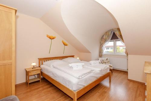 a bedroom with a bed and a window at Strandschloesschen-I-WE-19-682 in Kühlungsborn