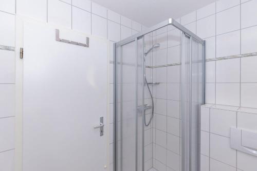 a shower with a glass door in a bathroom at Strandschloesschen-I-WE-19-682 in Kühlungsborn