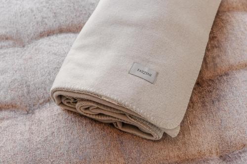 a close up of a blanket on a bed at LA CASA DI LAURA in Valdobbiadene