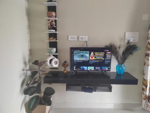 a computer monitor on a black desk in a room at Penthouse RK Beach in Visakhapatnam