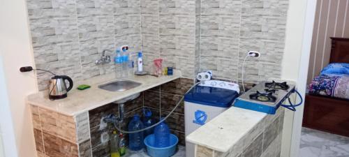 a small kitchen with a sink and a stove at Swan Nest in Alexandria