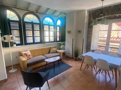 a living room with a couch and a table at Apartamentos Hevia in Villaviciosa