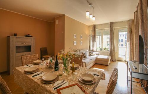 a living room with a table and a couch at 3 Bedroom Nice Apartment In Rovereto in Rovereto