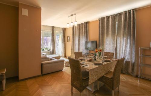a dining room with a table and a couch at 3 Bedroom Nice Apartment In Rovereto in Rovereto