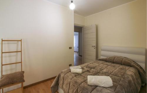a bedroom with a bed with two towels on it at 3 Bedroom Nice Apartment In Rovereto in Rovereto