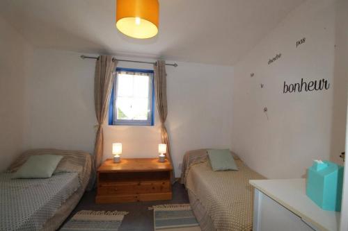 Cette chambre comprend deux lits et une table avec deux bougies. dans l'établissement Maison avec jardin à Villeneuve-de-Berg, piscine partagée, à Villeuneuve-de-Berg