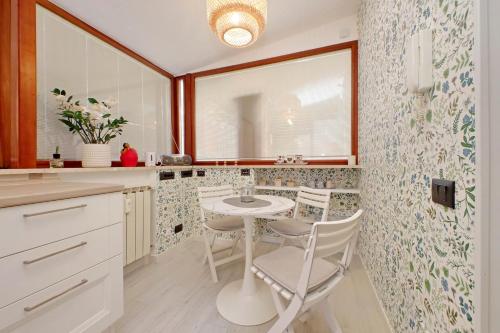 a kitchen with a table and chairs in it at 4BNB - Ponte Milvio Apartment in Rome