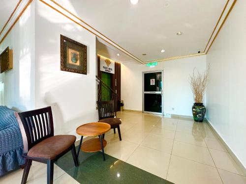 a living room with two chairs and a table at VALLEY HOTEL in Kota Kinabalu