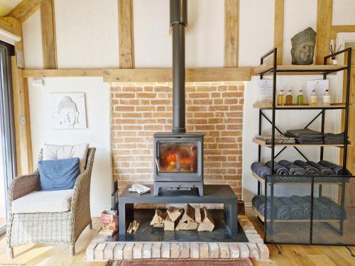 a fireplace in a living room with a stove at Sussex Barns - Horsham in Horsham