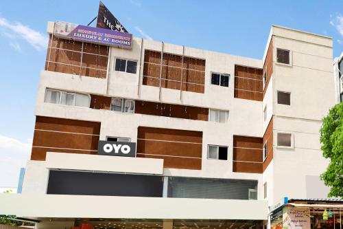 a building with a sign on top of it at Super OYO Flagship Kompally Residency in Hyderabad