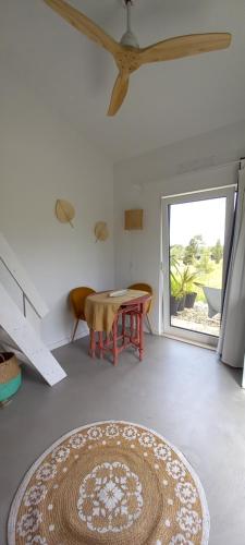 a living room with a table and a rug at Monte da Urze Aljezur in Aljezur