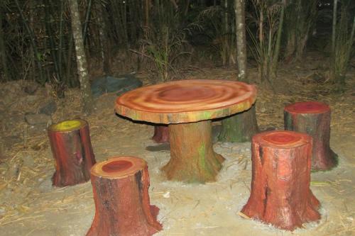 a painting of a tree stump table in the woods at Greenwoods Nature Camp in Mudumalai National Park