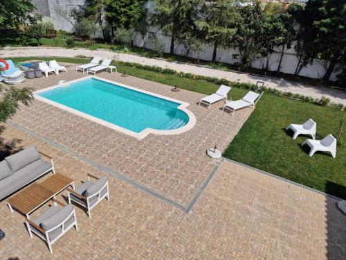 a swimming pool with chaise lounge chairs and a swimming pool at Casa das Portas in Azinhaga