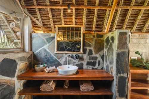 a bathroom with a sink on a wooden table at Mwazaro Beach Lodge in Shimoni