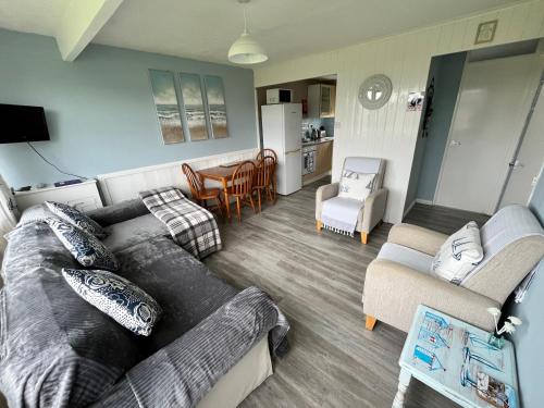 a living room with a couch and a table at California Beach Chalet in Great Yarmouth