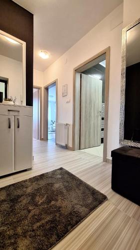 a large living room with a large sliding glass door at Apartman Lucille in Osijek