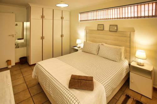 a bedroom with a large bed with a wooden headboard at Top Deck, Langebaan in Langebaan