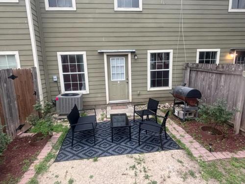 a patio with chairs and a grill in front of a house at King's Camp - SEAWORLD and MEDICAL Center, Yard, BBQ, Garage in San Antonio