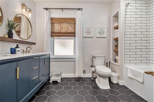 a bathroom with a toilet and a sink at Large Midtown Home With King Beds, Bunk Room, and Arcade in Omaha