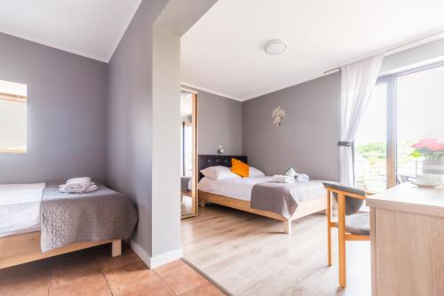 a bedroom with two beds and a window at ReveliQa2 in Pobierowo