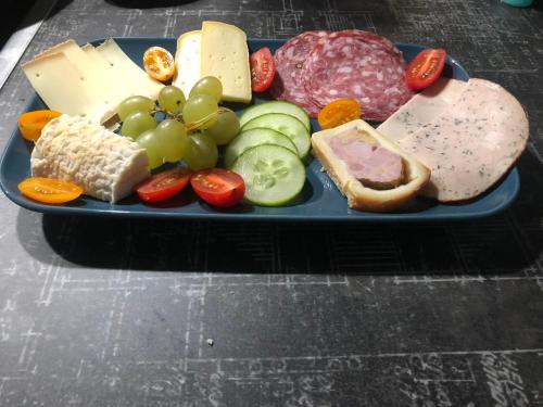 un plato azul de queso y carnes y hortalizas en Chambres d'Hôtes Le Felseneck - NOUVEAU PROPRIÉTAIRE - NEW MANAGEMENT, en Ferrette